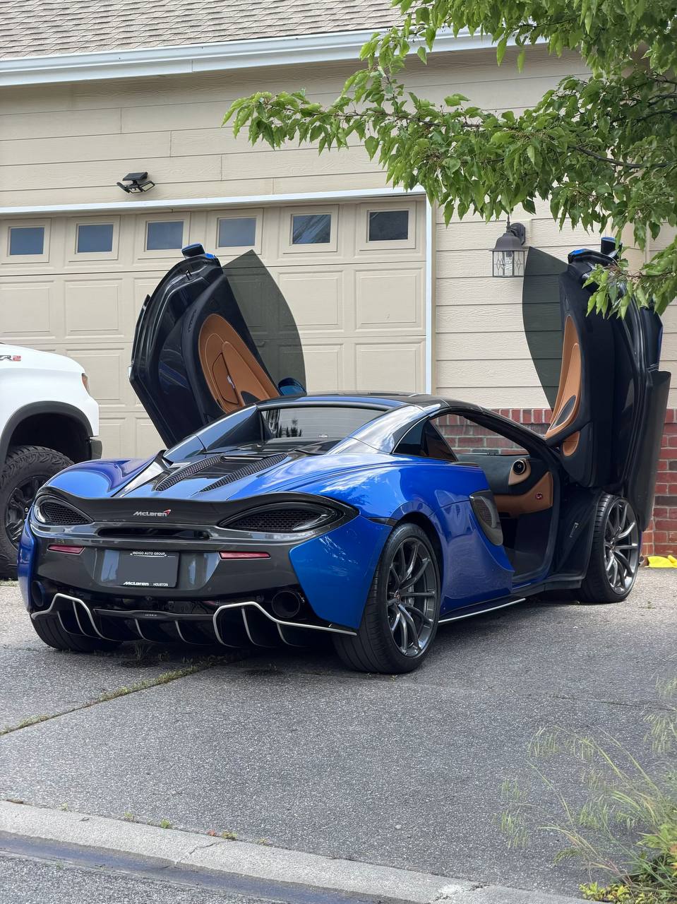 Blue McLaren 570S detailed in Spokane driveway
